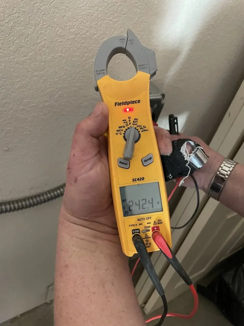 Voltage testing with clamp meter during Recessed Lighting Installation in Rockton